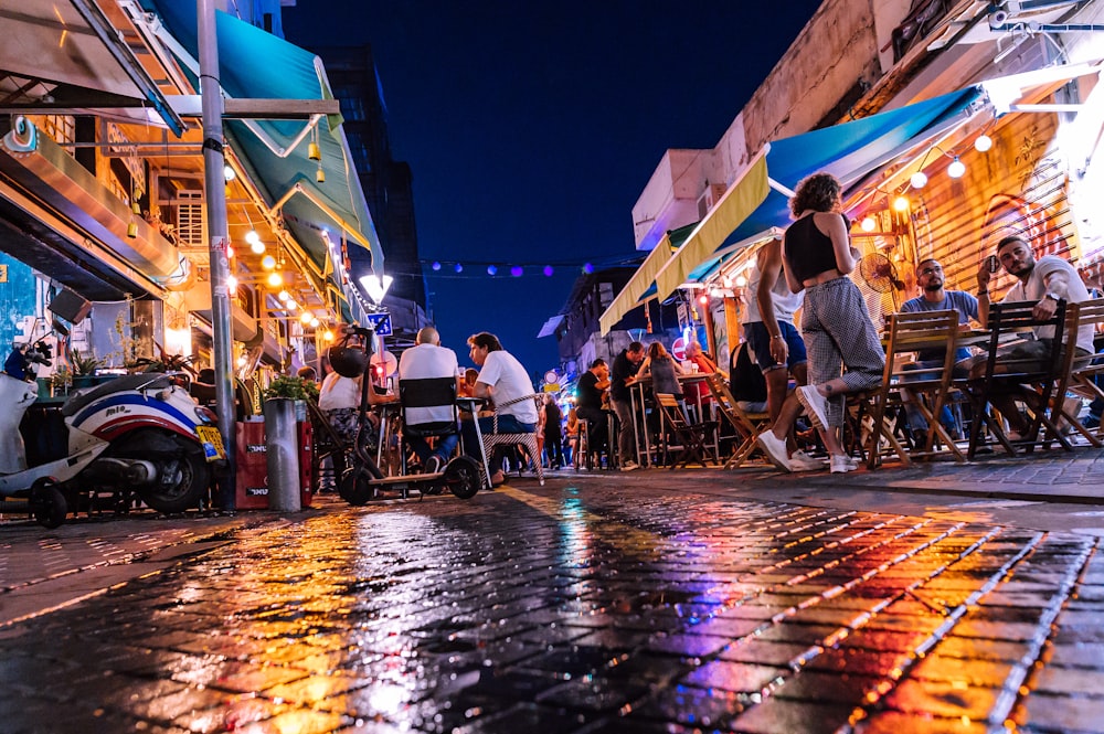 people sitting on chair near building during night time