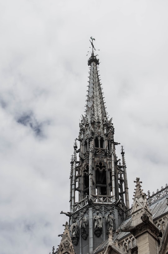 gray concrete tower under white clouds during daytime in Sainte-Chapelle France