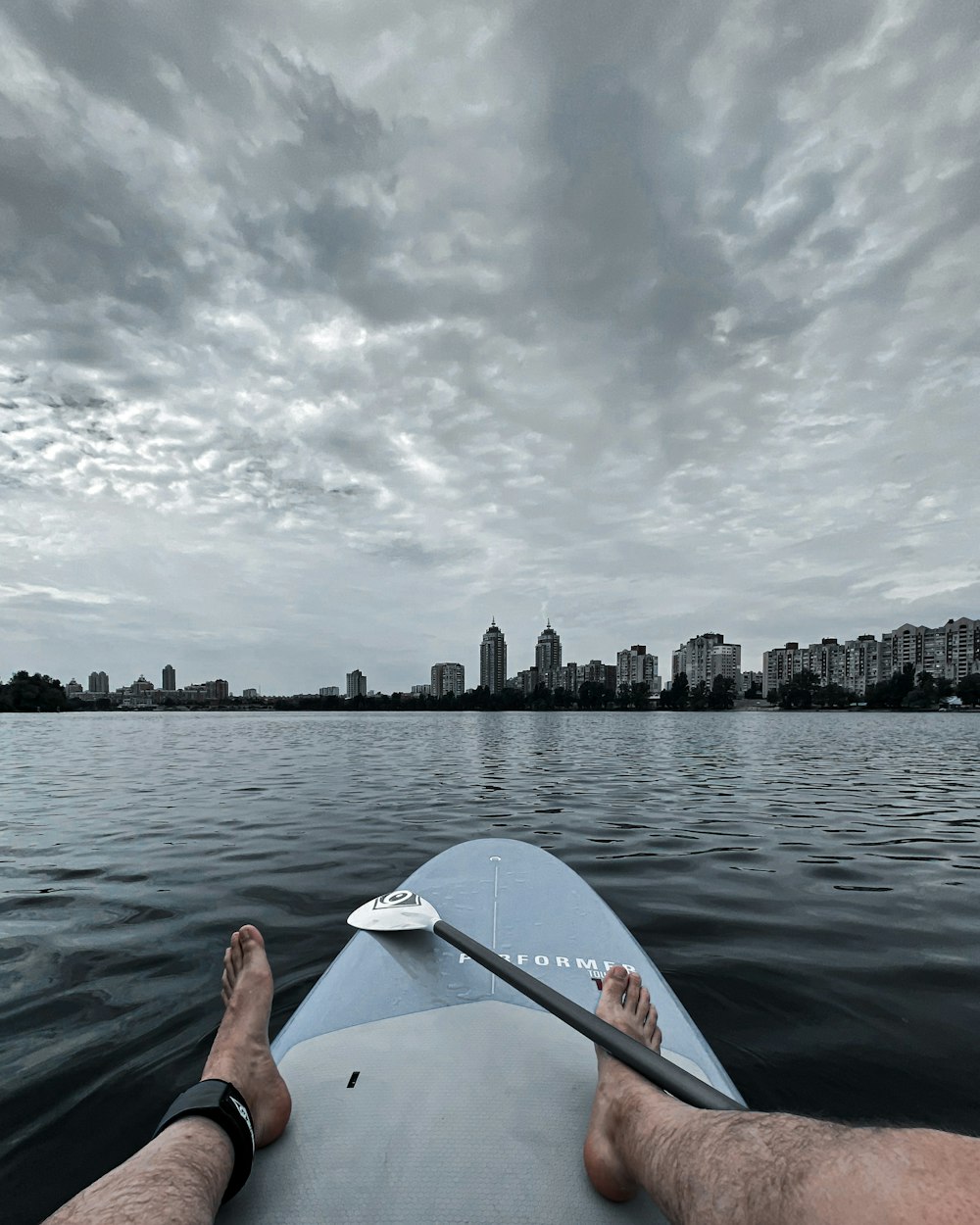 person in red kayak on body of water during daytime