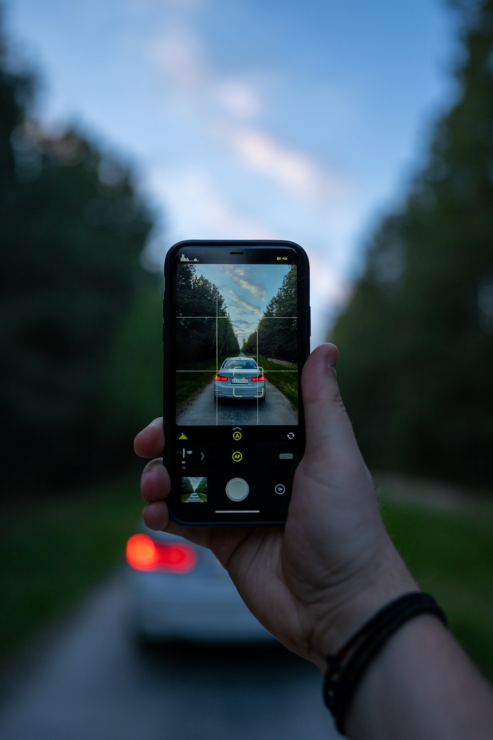 person holding black iphone 4