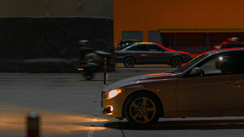 a car parked in a parking lot next to a motorcycle