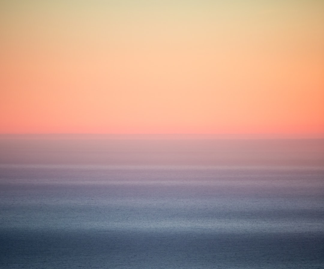 blue body of water under blue sky during daytime