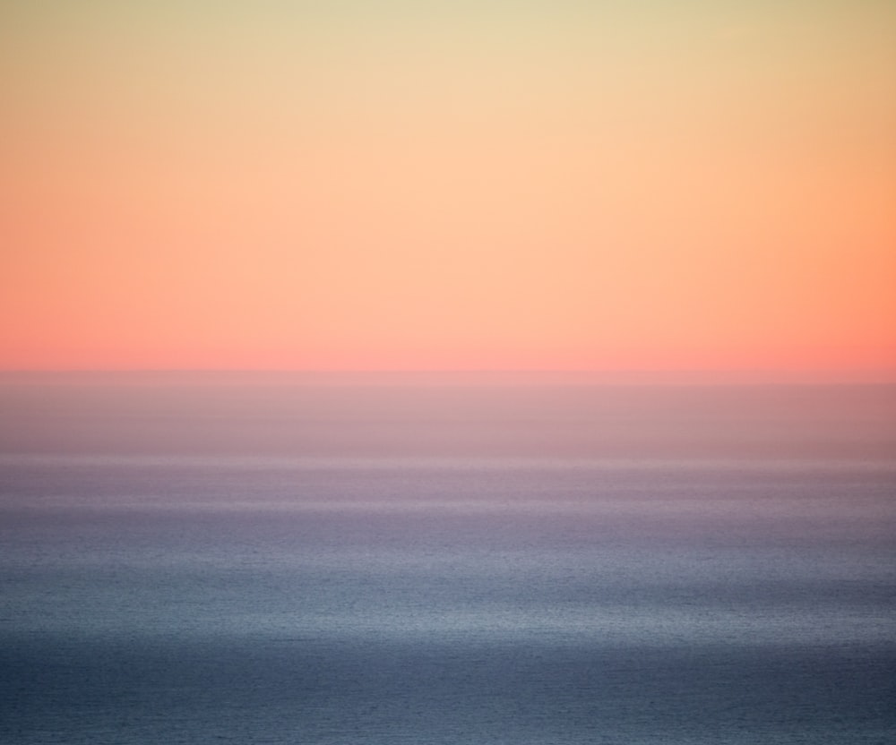 blue body of water under blue sky during daytime