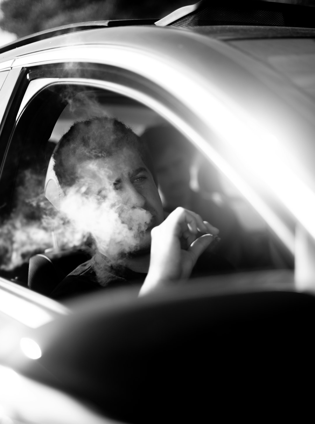 man in black shirt sitting inside car