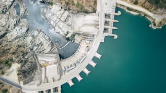 aerial view of white concrete building near body of water during daytime