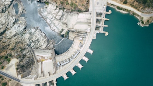 aerial view of white concrete building near body of water during daytime