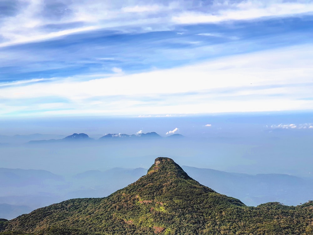 green mountain under white clouds during daytime