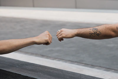 Close-up of hands performing a fist bump symbolizing teamwork and trust.