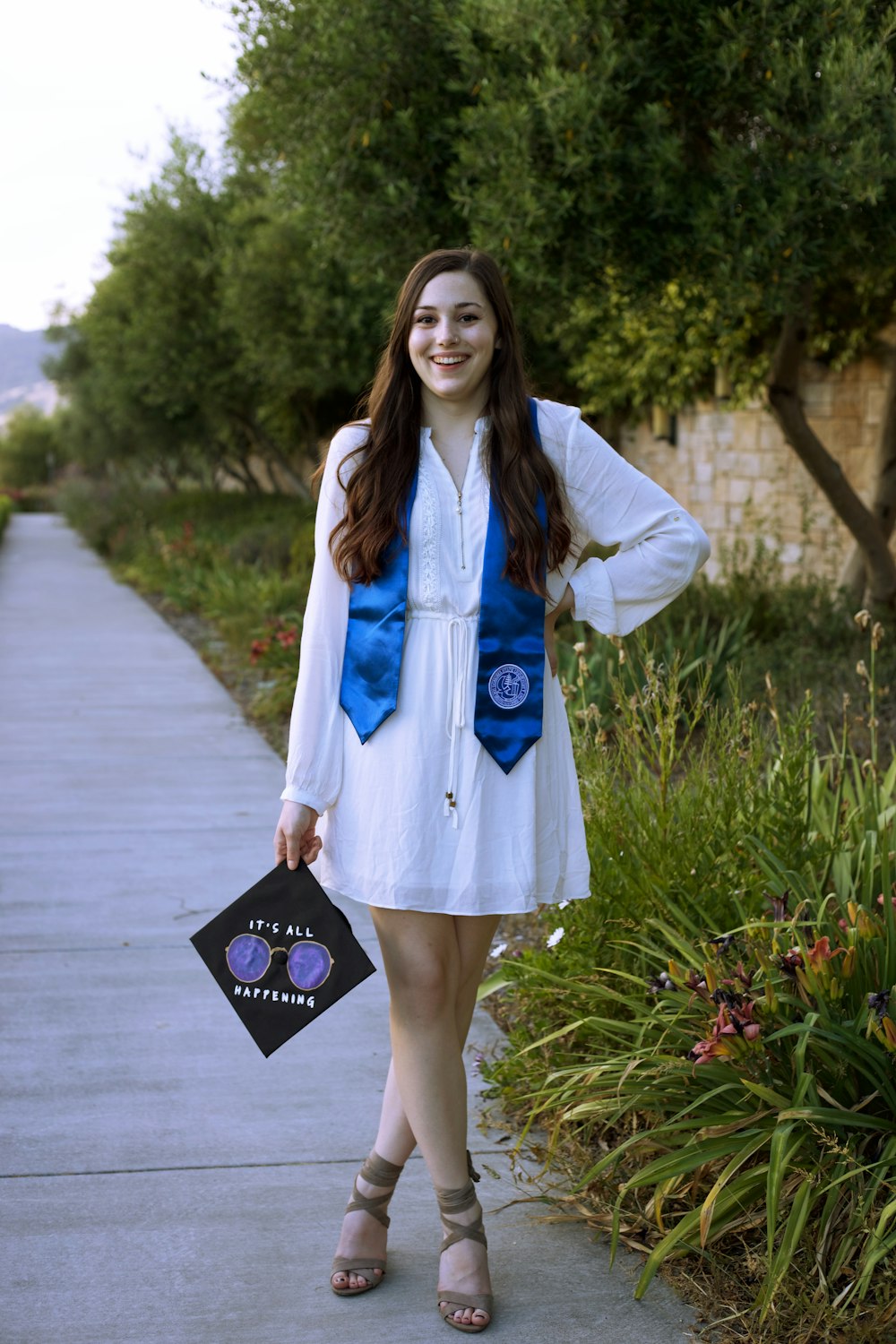 woman in blue and white coat holding brown book