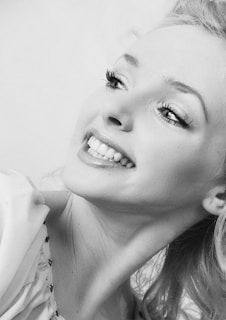 A joyful woman smiling brightly, symbolizing resilience and hope after overcoming challenges.