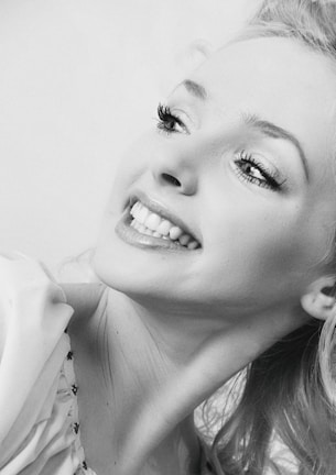 Portrait of a young African woman smiling, embodying hope and leadership.
