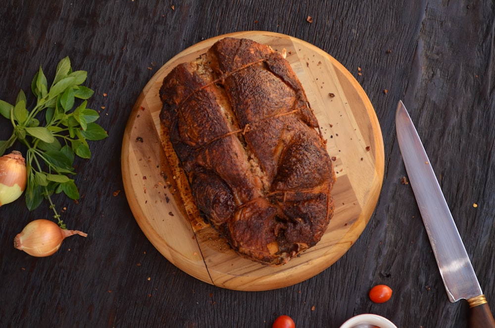 brown meat on brown wooden round plate