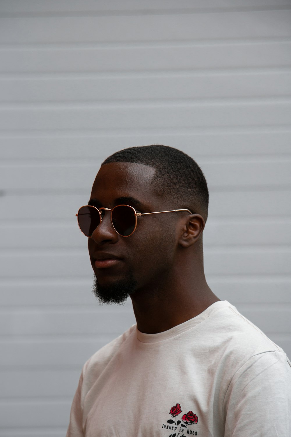 man in white crew neck shirt wearing black framed eyeglasses