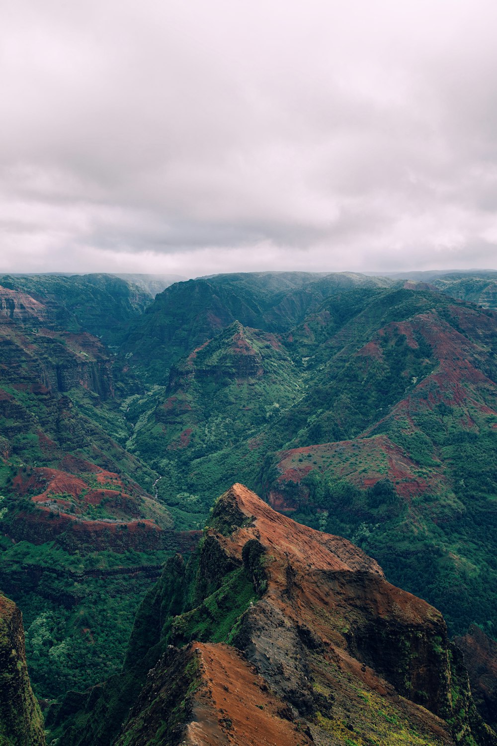 green and brown mountains under cloudy sky during daytime