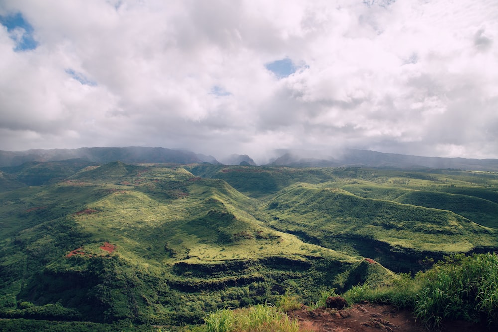 green mountains under white clouds during daytime