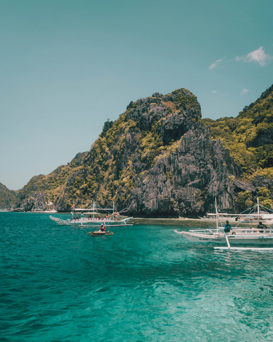 White boat beside a limestone rock formation