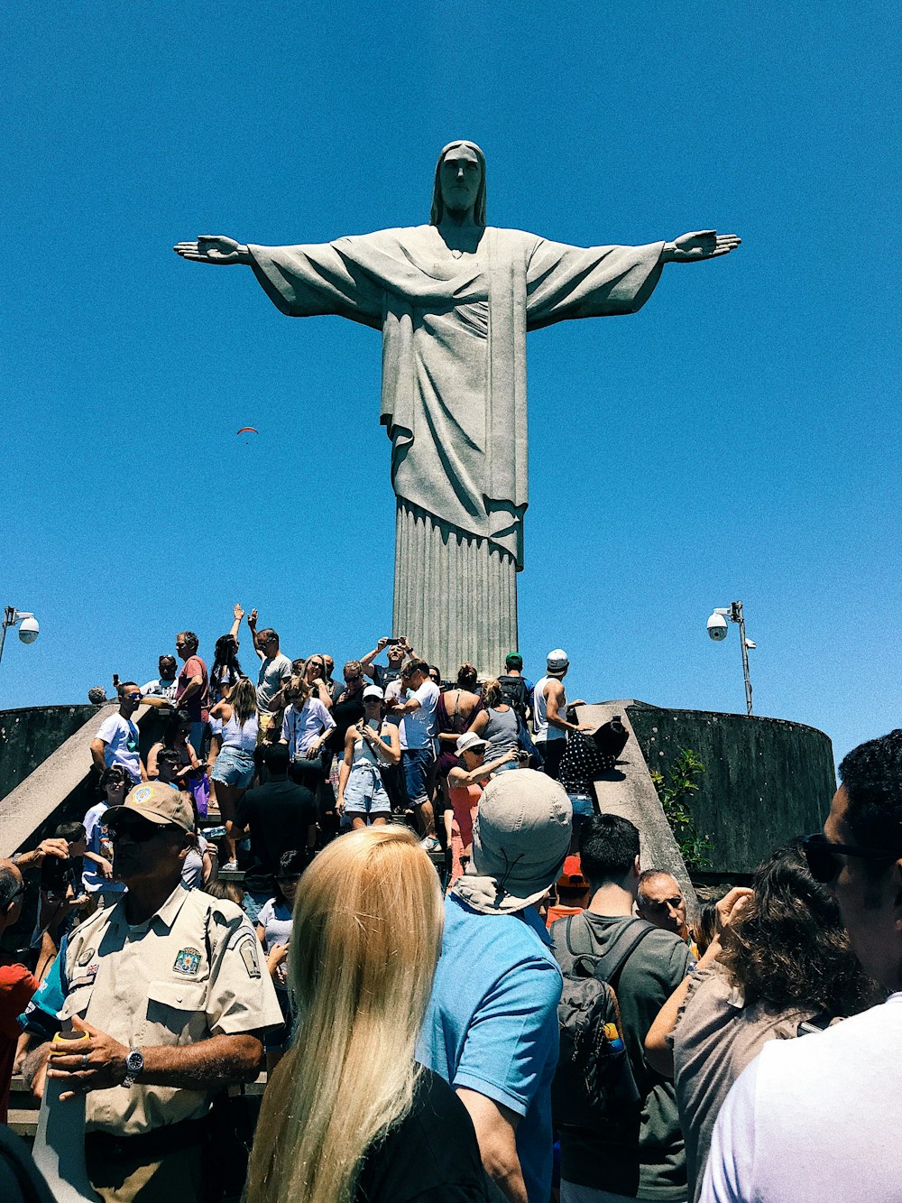 people gathering in a park with statue of liberty in the distance