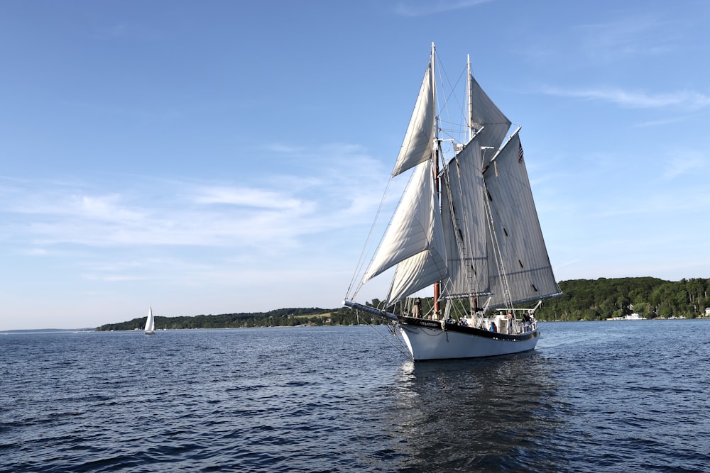 white sail boat on sea during daytime