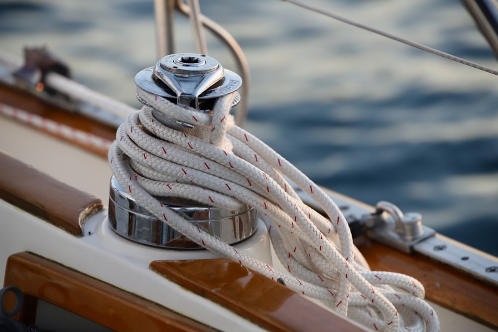 white and brown boat with rope