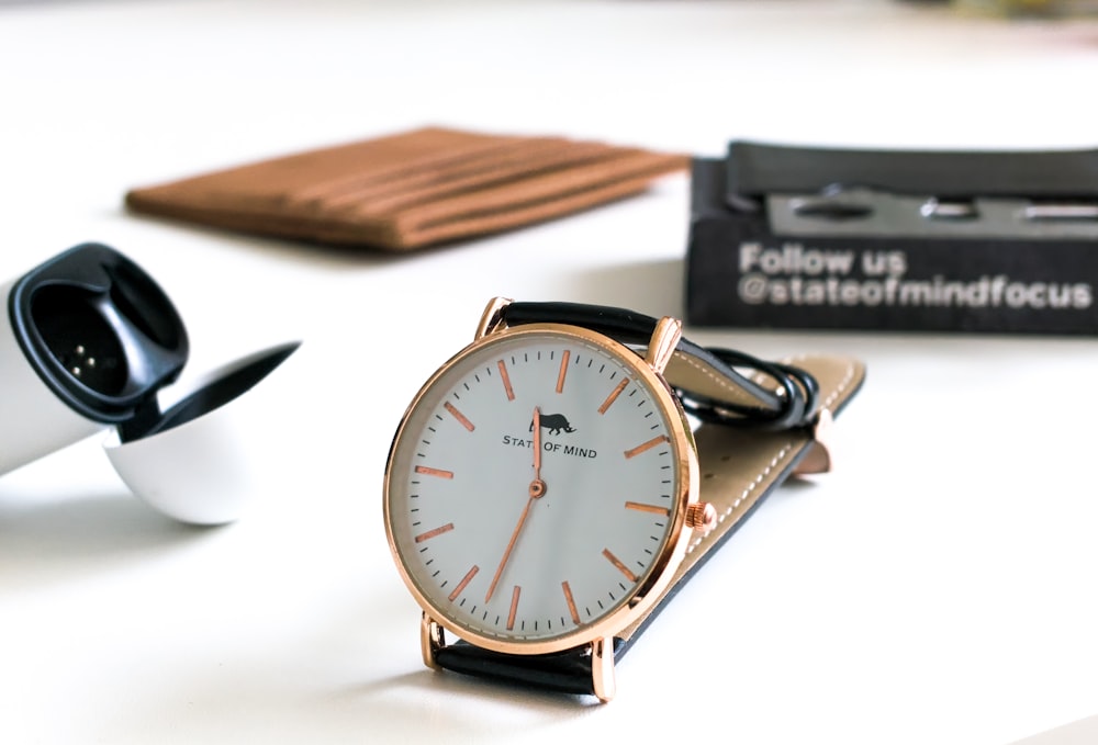 silver and gold round analog watch