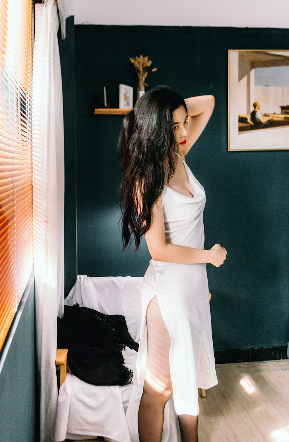 woman in white dress standing near black wooden door