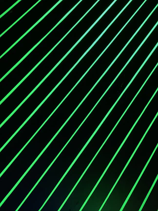 Close-up of a holographic interface glowing with lime green neon lines against a dark gray background.
