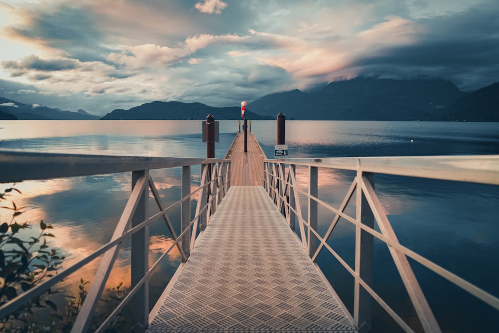 brown wooden dock on body of water during daytime