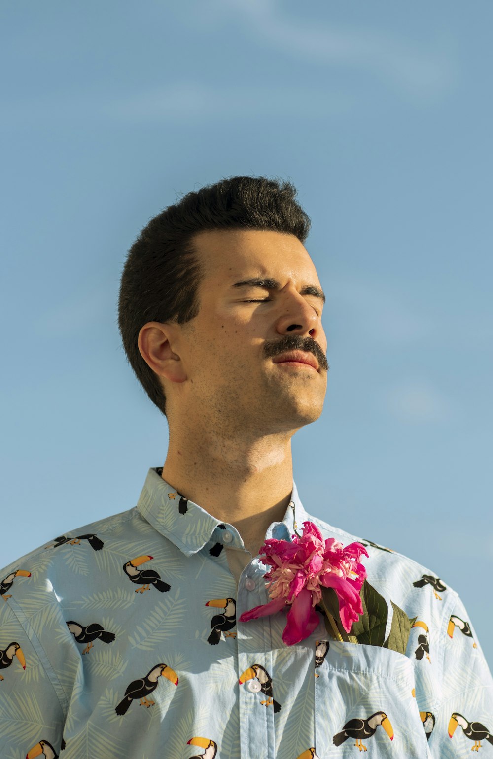 man in blue and white floral button up shirt