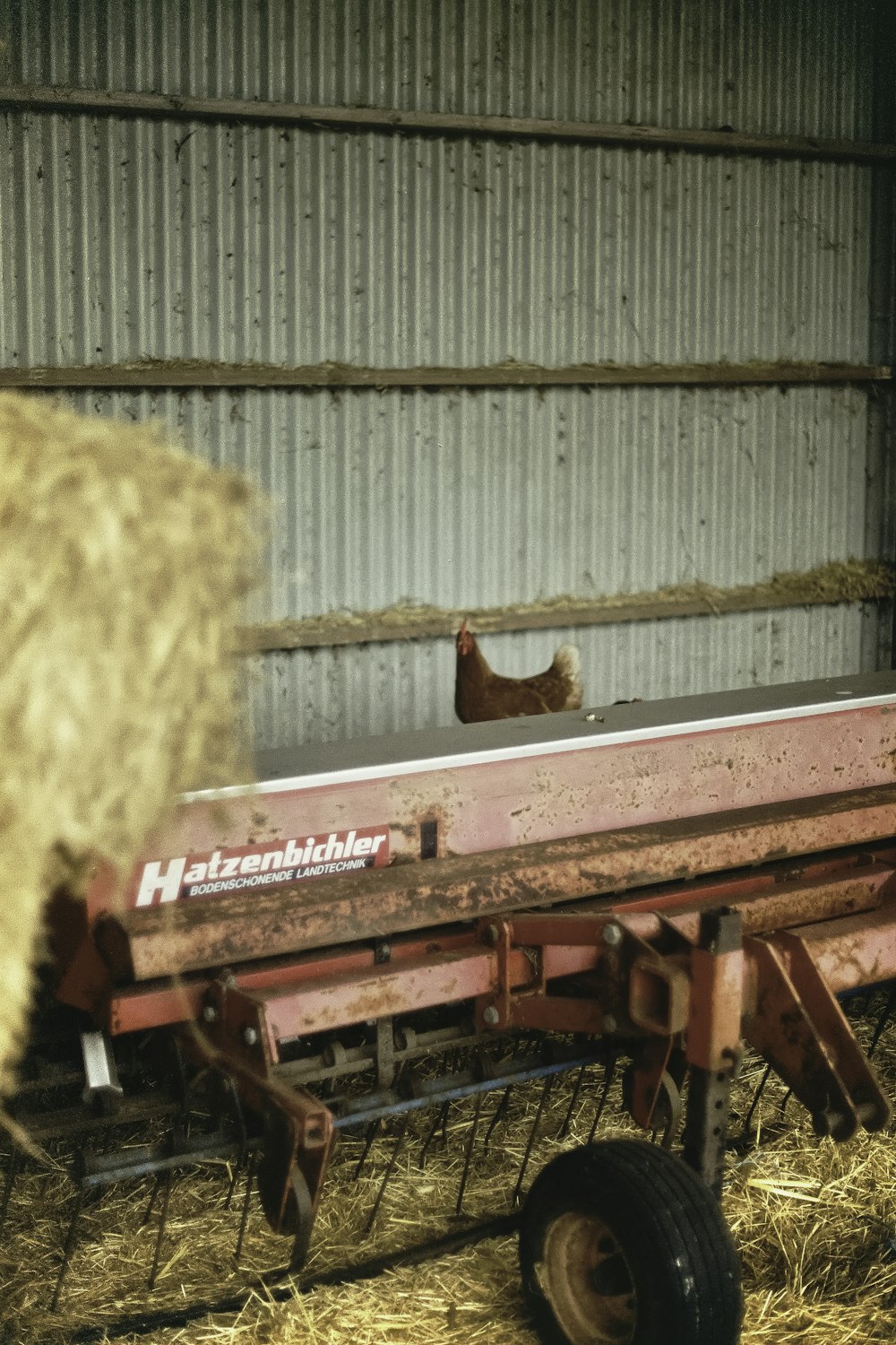 red tractor near brown hay