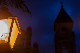 A warm-lit lamppost glowing softly against a twilight cityscape, symbolizing guidance and innovation.