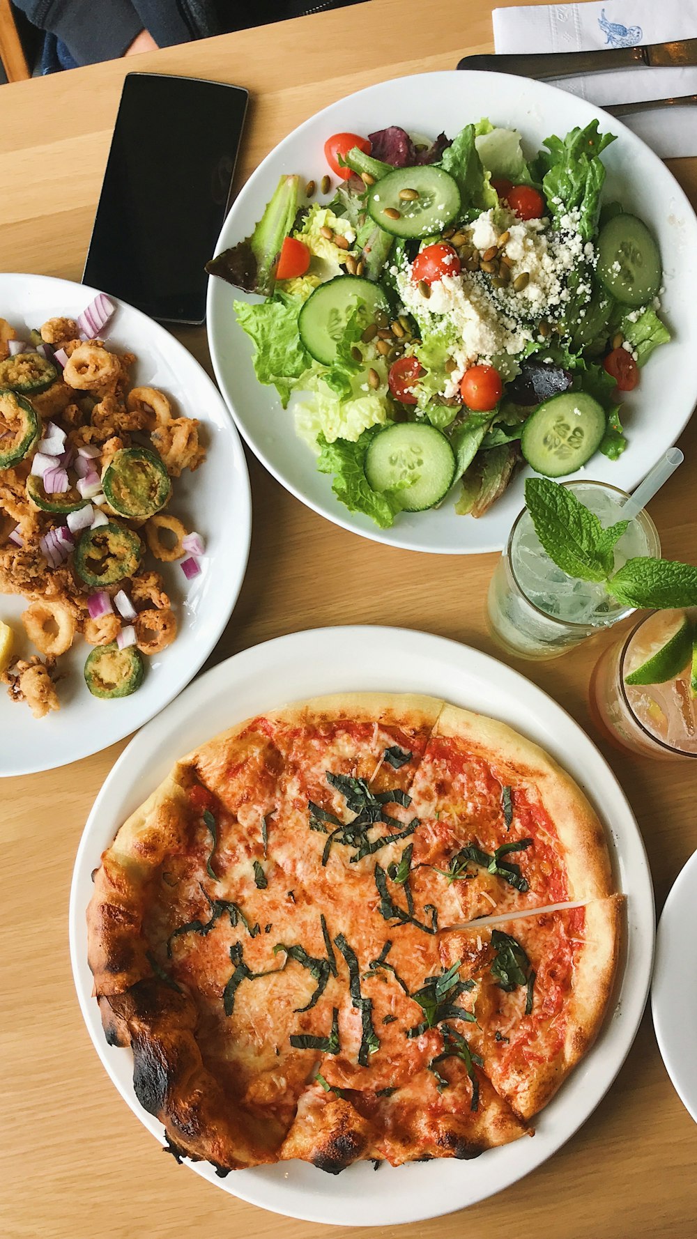 pizza with sliced cucumber on white ceramic plate