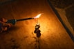 Hands lighting a firework fuse outdoors