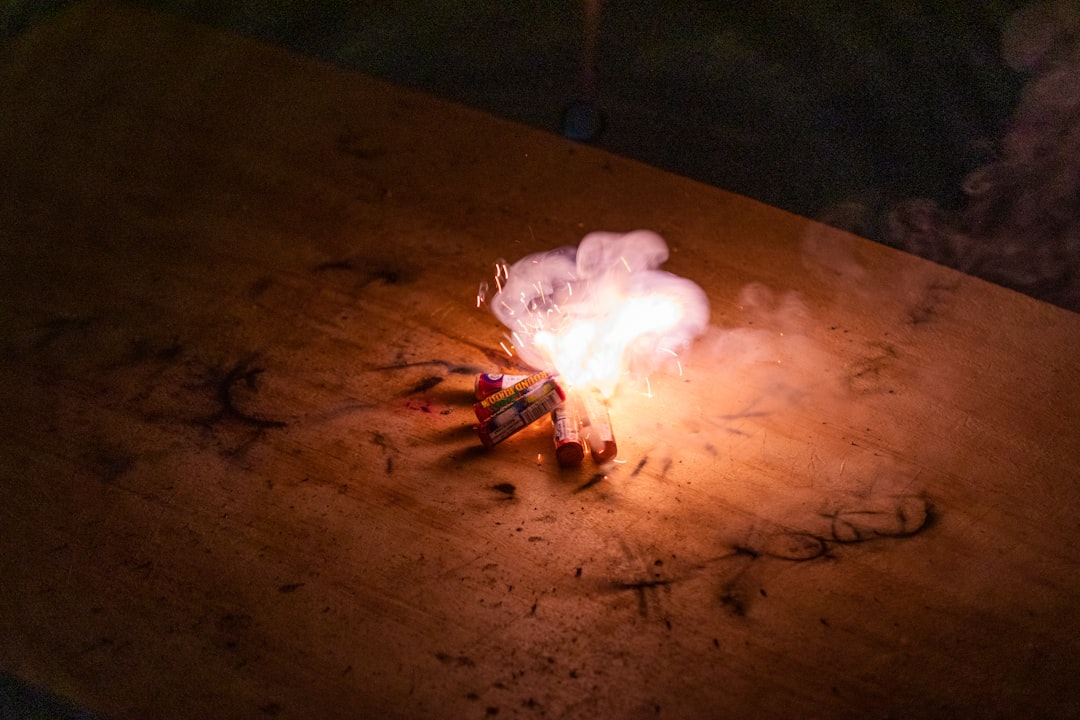 white and red fire on brown wooden table