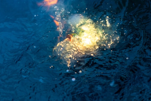 LED pool lights glowing underwater in vibrant colors at night.