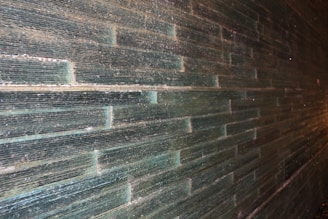 Wall tiles with subtle texture adding depth to a bathroom wall.