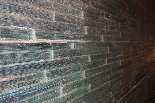Wall tiles with subtle texture adding depth to a bathroom wall.