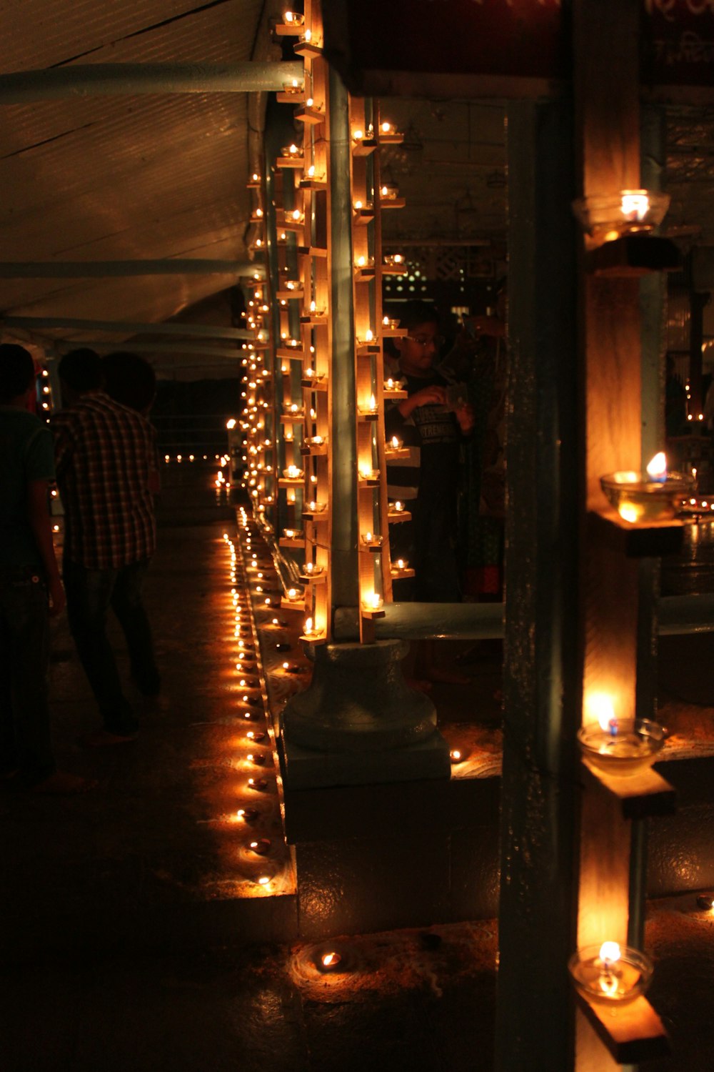 people standing near lighted candles