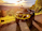 A rugged ATV with a bright yellow bumper is parked on a gravel path, facing a lush, sunlit valley. The landscape is filled with rolling green hills and scattered trees, with a vibrant sunset casting warm hues over the scene.