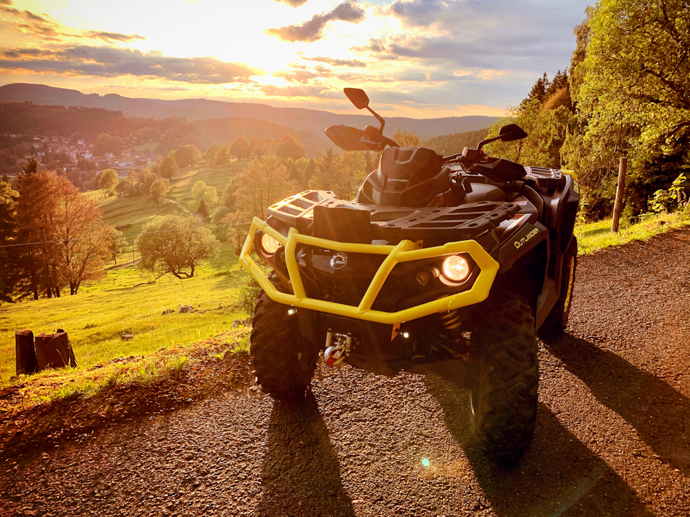 black and gray atv on brown field during daytime