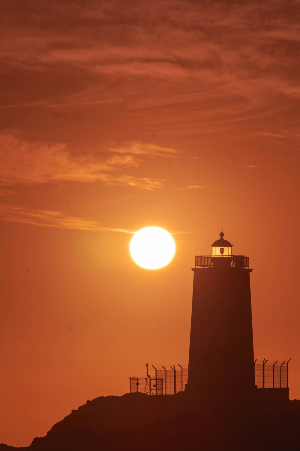 Silhouette des Leuchtturms bei Sonnenuntergang