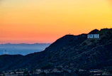 A sunset view of Los Angeles skyline with a display of vegafornia & co. gift packages in the foreground.