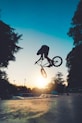 man riding on bicycle on road during daytime