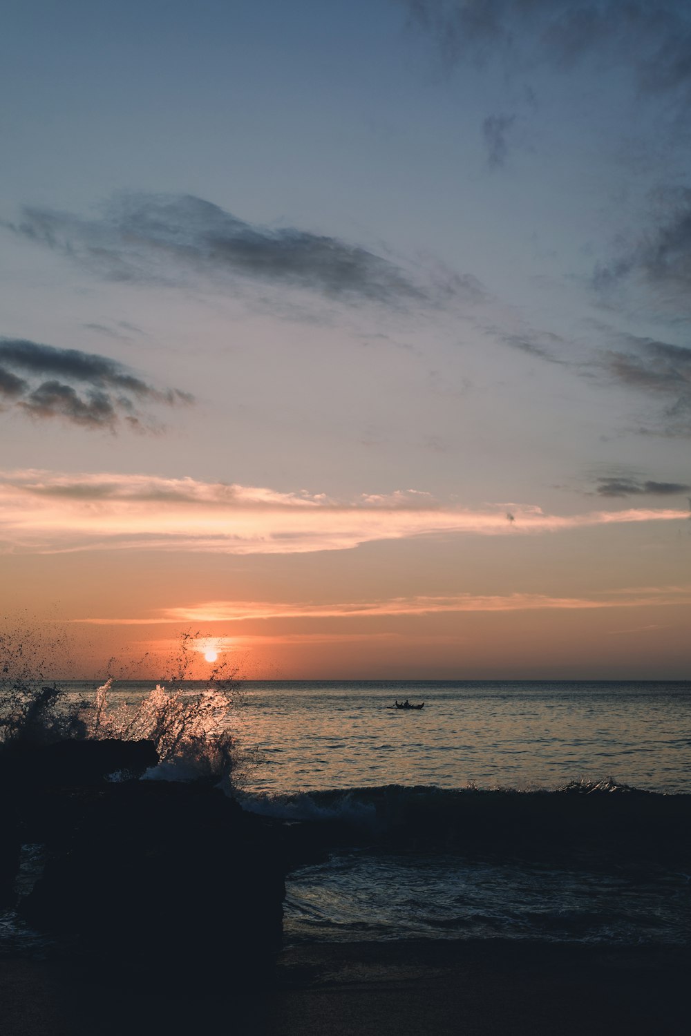 silhouette of trees near body of water during sunset