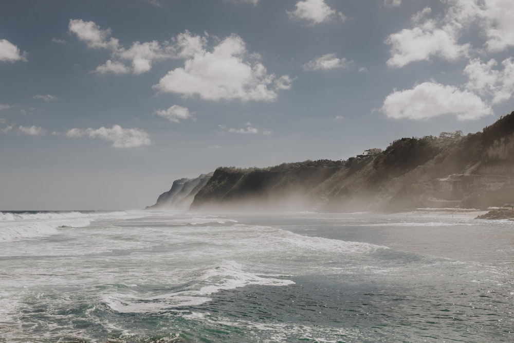 ocean waves crashing on shore during daytime