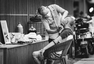man in button up shirt sitting on chair