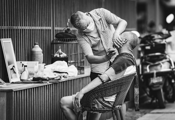 man in button up shirt sitting on chair