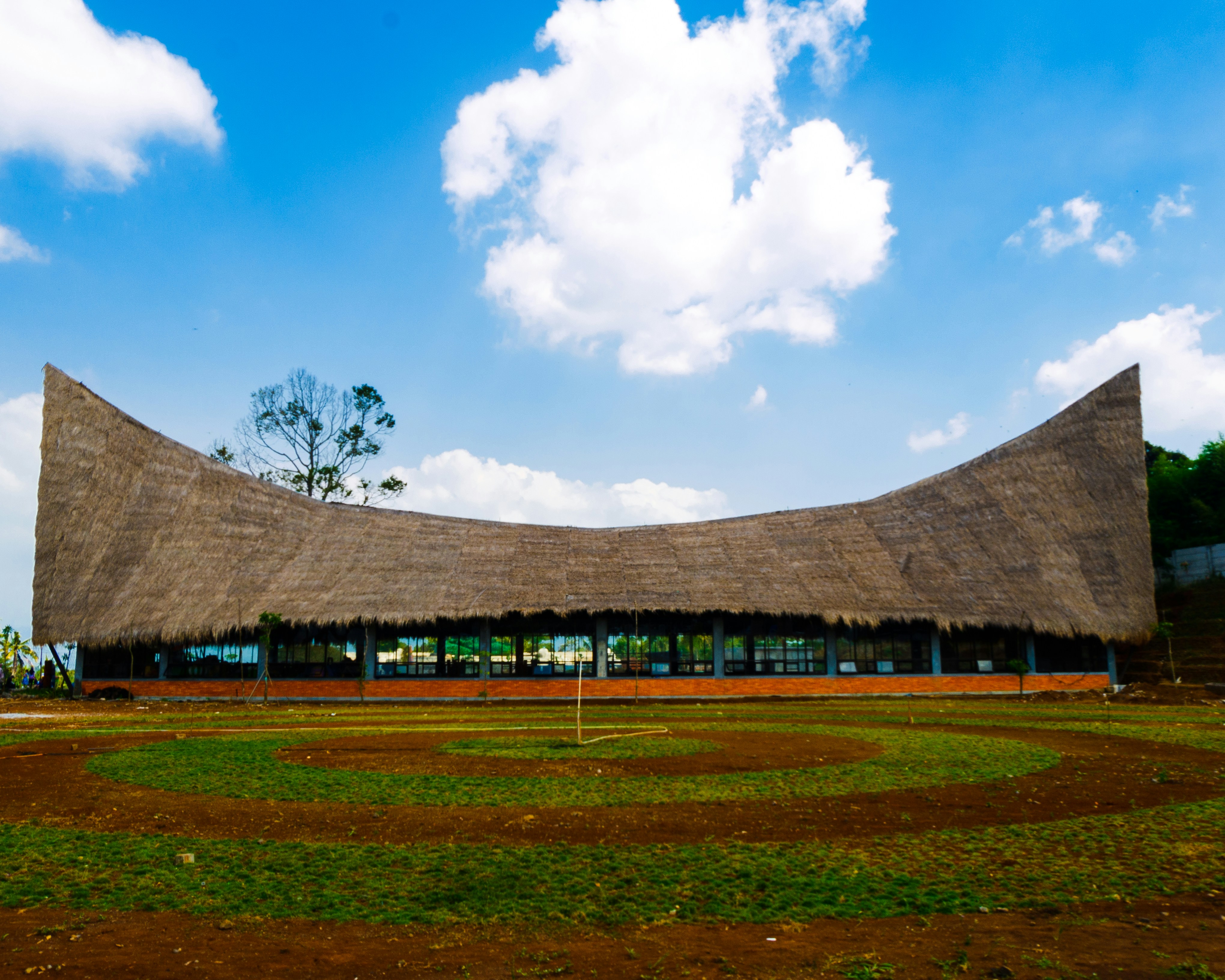 Brown wooden house near green grass field under blue sky during daytime ...