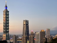 The modern skyline of Riyadh with iconic skyscrapers glowing at dusk.