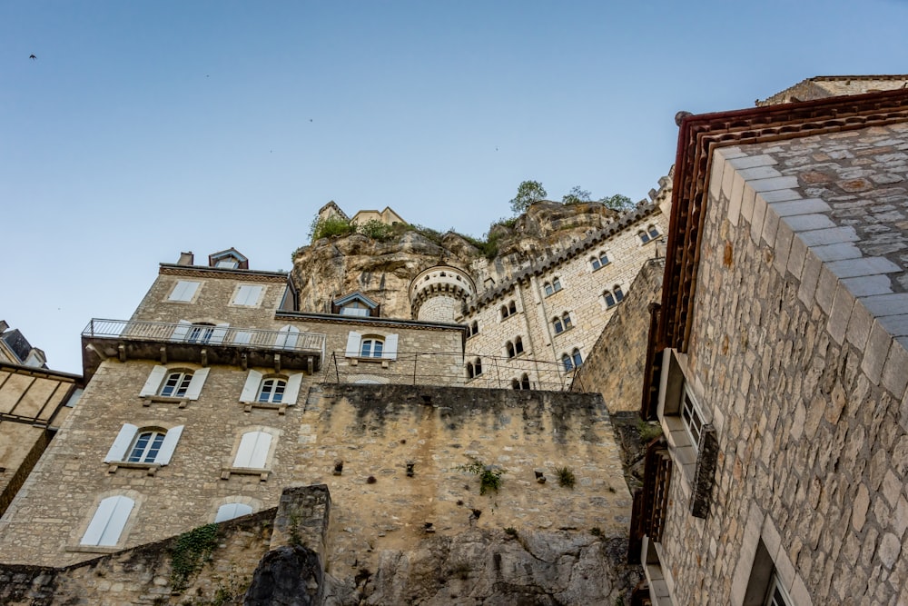 brown brick building on top of mountain during daytime