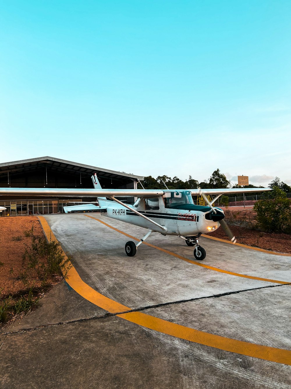 white and blue airplane on brown ground during daytime